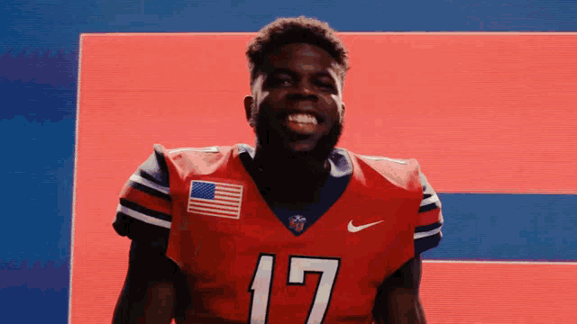 a man in a red nike jersey with the number 17 on it
