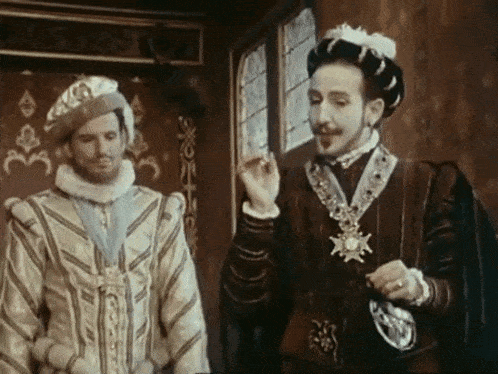 two men in costume are standing next to each other in a room