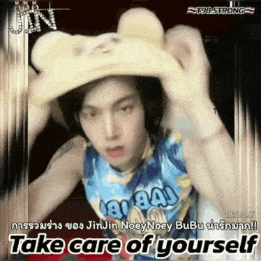 a man wearing a cowboy hat and a shirt that says ' take care of yourself ' on it