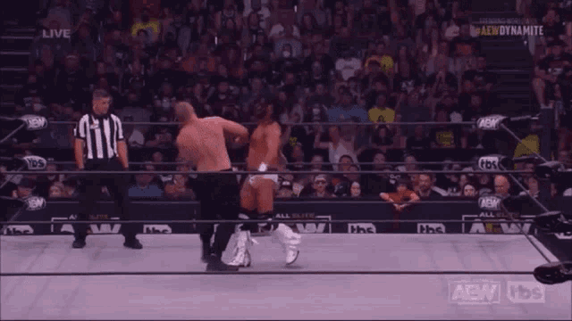 a man in a wrestling ring with a tbs logo