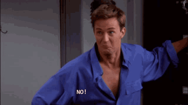 a man in a blue shirt has the word no written on his chest