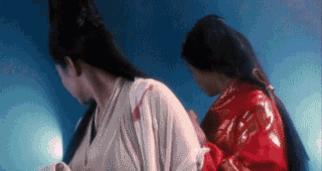 a man and a woman are standing next to each other in a dark room .