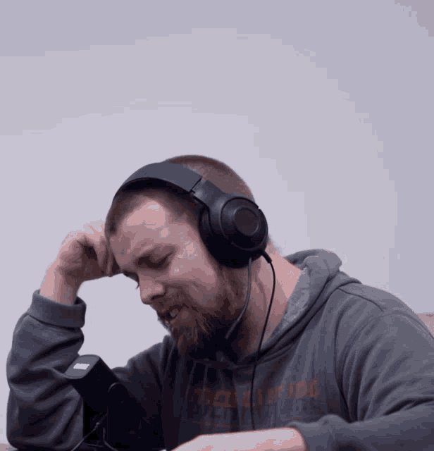 a man wearing headphones is wearing a sweatshirt that says stockton