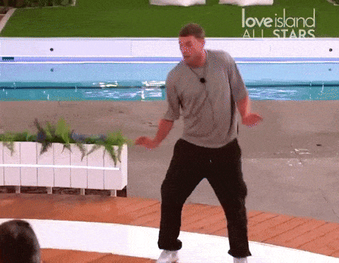 a man dancing in front of a love island all stars sign