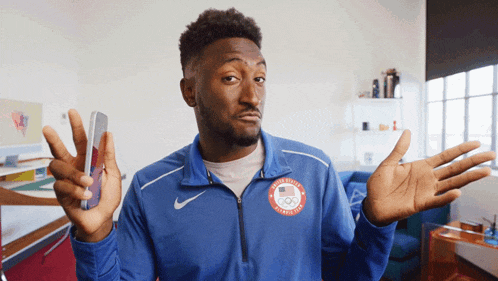 a man wearing a blue jacket with the word united states on it