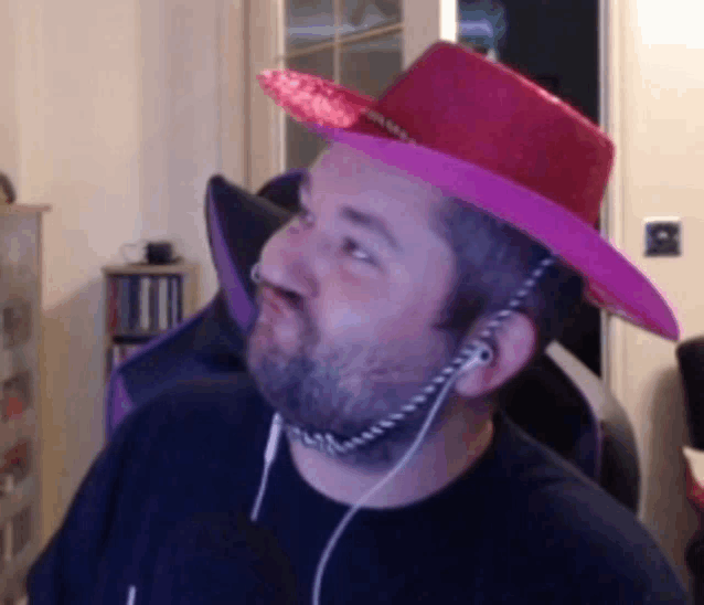 a man wearing a cowboy hat and ear buds