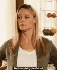a woman is standing in a kitchen with her hands on her hips and says `` he married a lesbian '' .