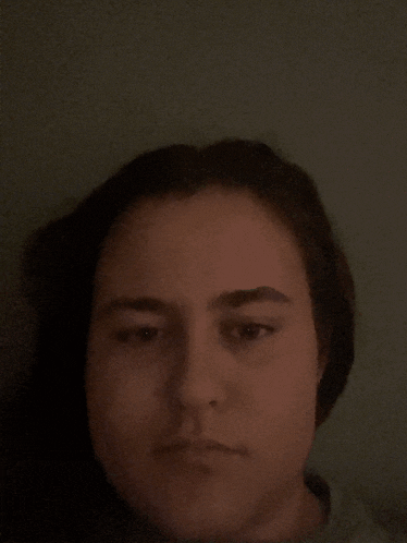 a close up of a woman 's face in the dark