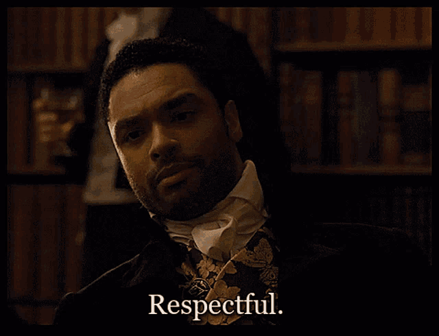 a man in a suit and tie says respectful in a library