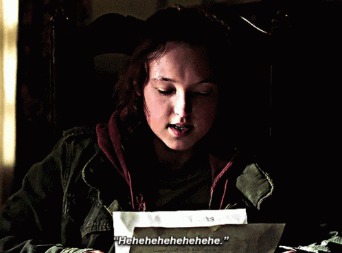 a woman sitting in a chair holding a piece of paper that says ' hhhhe ' on it