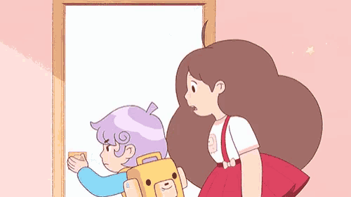 a girl and a boy are standing next to each other in a room .