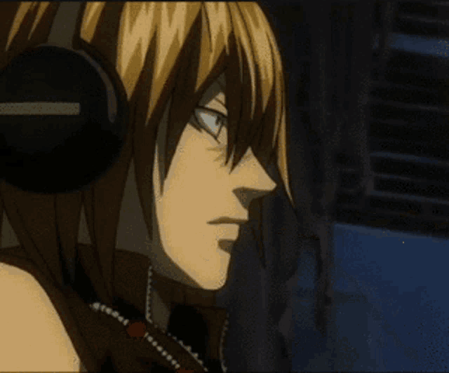 a close up of a person wearing headphones and holding a stick