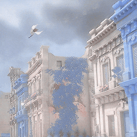 a blurry picture of a blue building with a bird flying in front of it