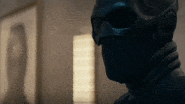 a close up of a person wearing a black mask