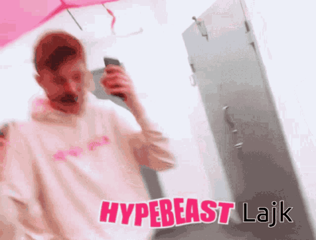 a blurry picture of a man talking on a cell phone with the words hypebeast lajk written above him