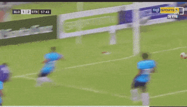 a soccer game is being played in front of a tico sports banner