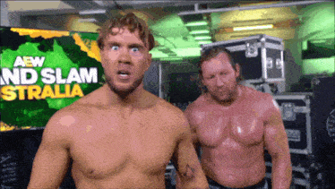 two wrestlers are standing in front of a sign that says aew and slam australia