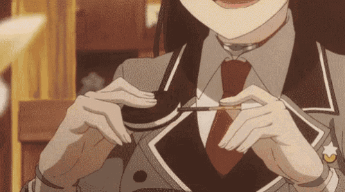 a girl in a suit and tie is holding a piece of paper in her hand .