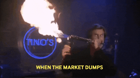 a man is blowing fire in front of a sign for tino 's