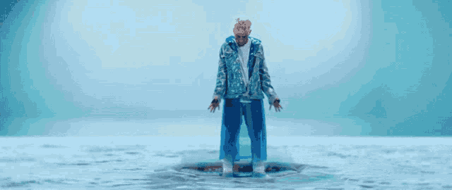 a man in a blue jacket is standing in a pool of water