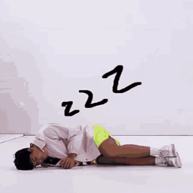 a person is laying on the floor with the letters zzz behind them