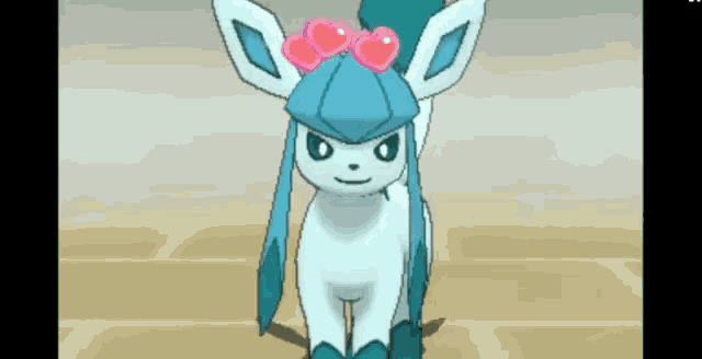a blue and white pokemon with a pink bow on its head .
