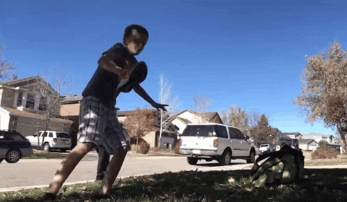 a boy playing frisbee in front of a ford van
