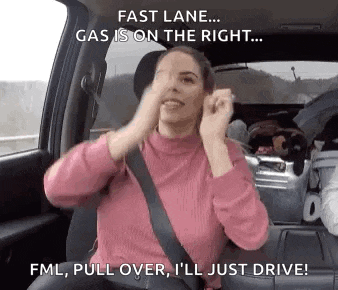 a woman is sitting in the driver 's seat of a car with her hands on her face .