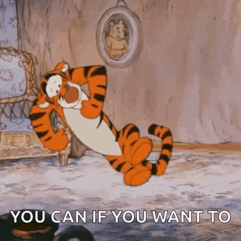 tigger from winnie the pooh is laying on the floor in a room with a picture on the wall .