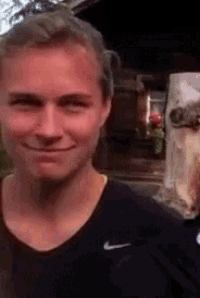a man wearing a black nike shirt is smiling for the camera