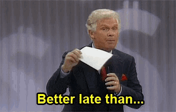 a man in a suit holding a piece of paper with the words better late than written below him