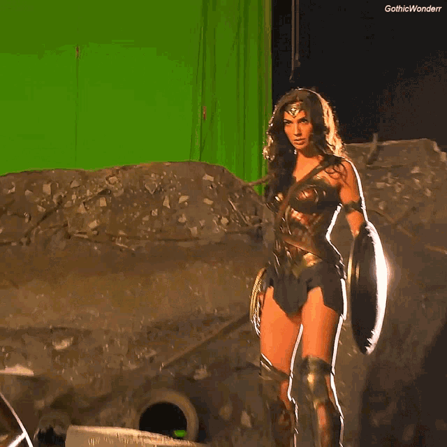 a woman standing in front of a green screen with the caption gothic wonderr