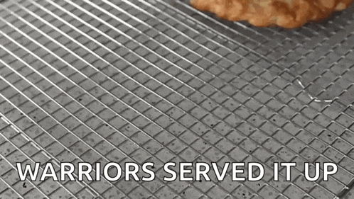 a cookie on a cooling rack with the words " warriors served it up " above it