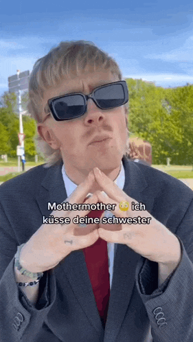 a man wearing sunglasses and a suit says mothermother ich kusse deine schwestern