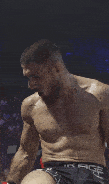 a shirtless man wearing a pair of shorts that say age
