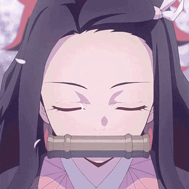 a close up of a girl with her eyes closed and a tube in her mouth