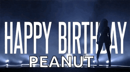 a sign that says happy birthday peanut with a woman dancing in the background