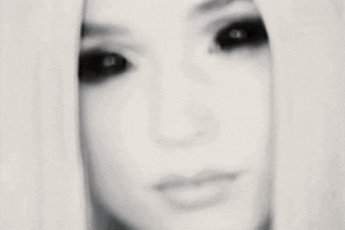 a close up of a woman 's face with long blonde hair