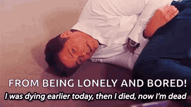 a man is laying on the floor with the words from being lonely and bored written above him
