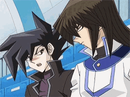 a couple of anime characters standing next to each other with one looking at the other