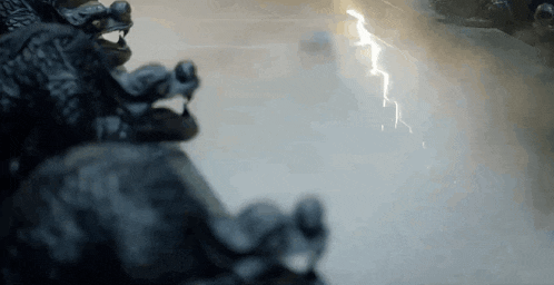 a close up of a statue of a dragon with a lightning bolt coming from it .
