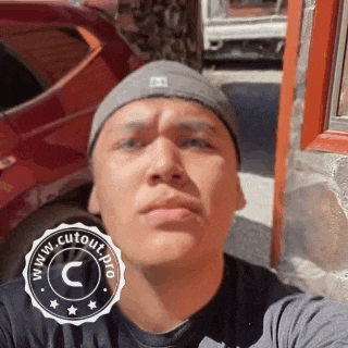 a man wearing a beanie is taking a selfie .