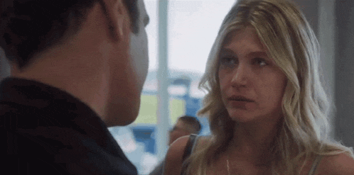 a man and a woman are looking at each other and talking .