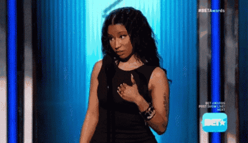 a woman in a black dress is standing on a stage with a bet logo in the background .