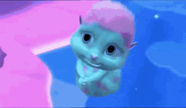 a blue and pink cartoon character is floating in the water .