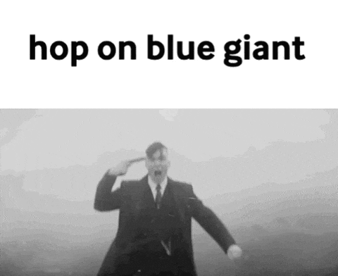 a man in a suit and tie is making a suicide gesture with his finger to his ear .