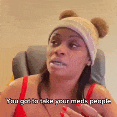 a woman wearing a beanie and a red tank top says you got to take your meds people .