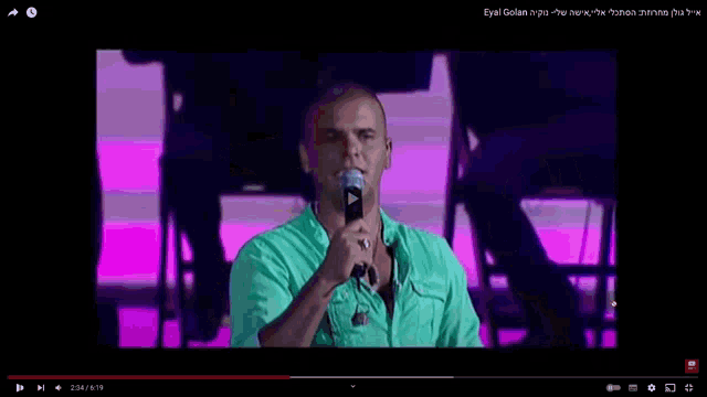 a video of a man singing into a microphone is being played on youtube