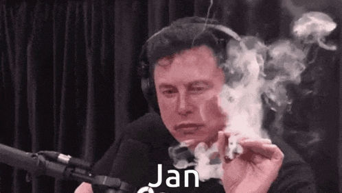 elon musk is smoking a cigarette in front of a microphone and smoke is coming out of his mouth .