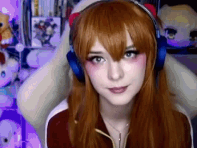 a woman wearing headphones is sitting in a chair and looking at the camera .